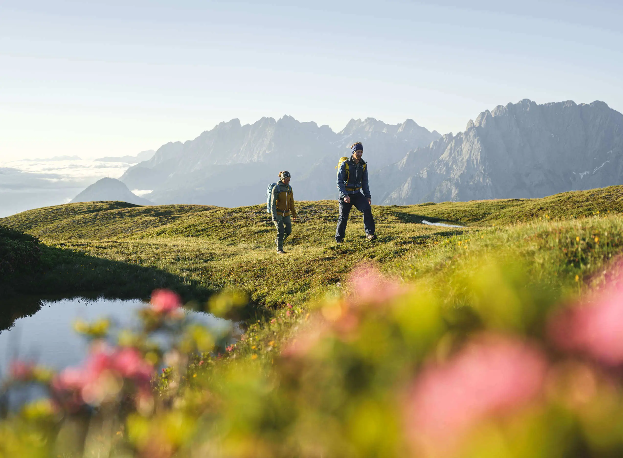 Two men hiking near holiday apartments in Sillian East Tyrol with mountain views and alpine meadows