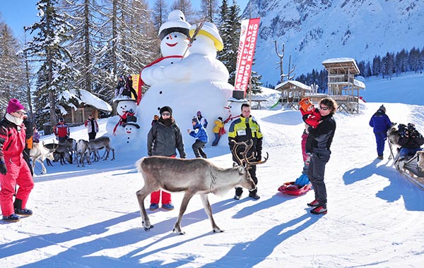 Family winter holiday in Sillian, Osttirol with reindeer, snowmen, and ski resort activities in the Alps